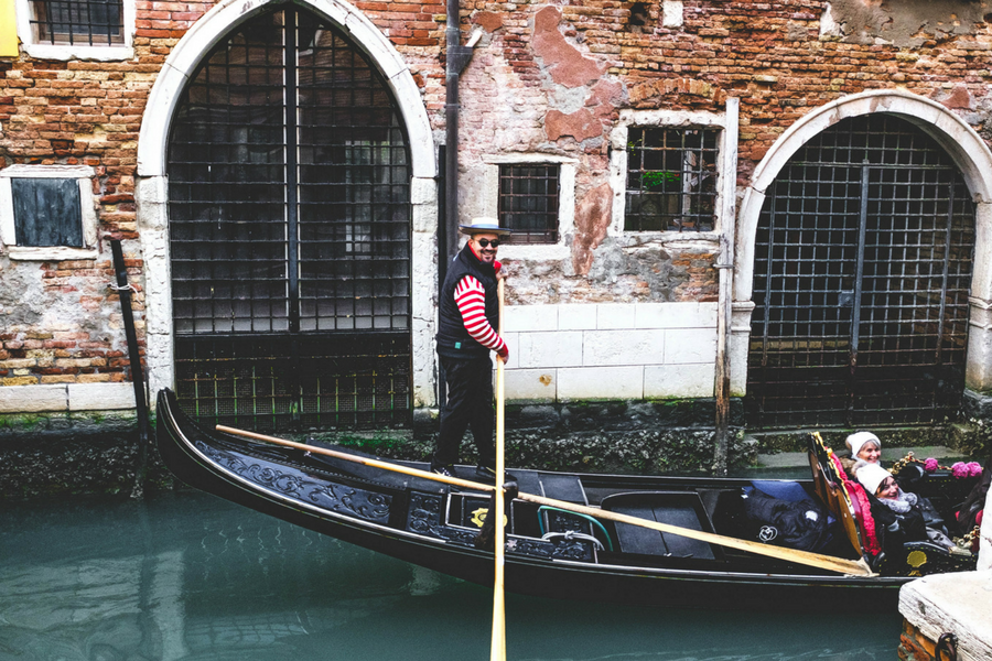 Gondolier and tourist on a gondola